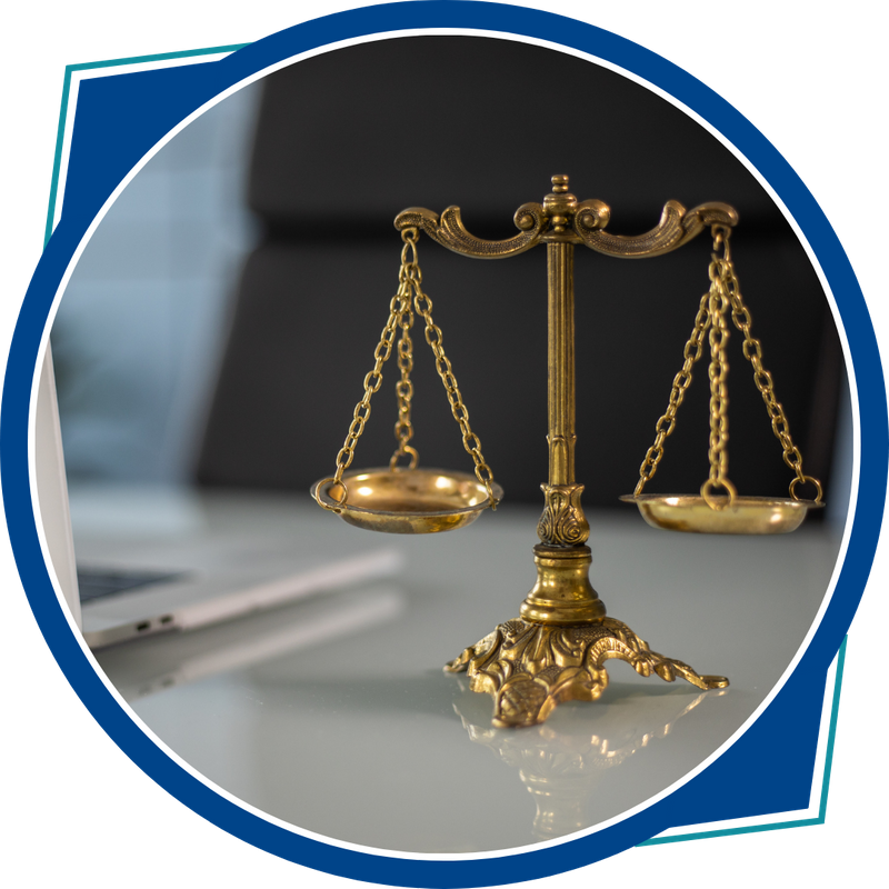 gold scales on desk next to laptop