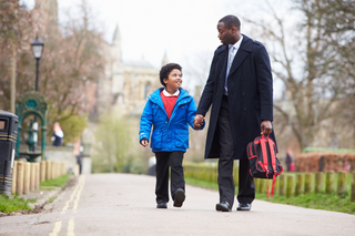 man walking holding child's hand